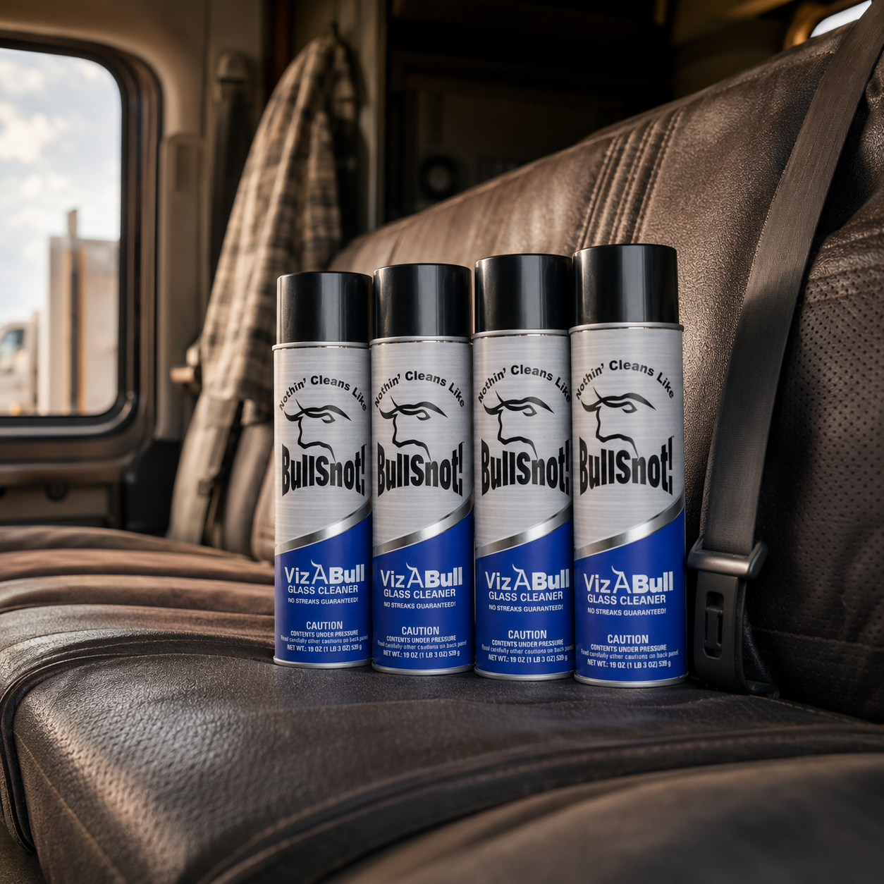 A four-pack of VizABull glass cleaner cans on a truck seat