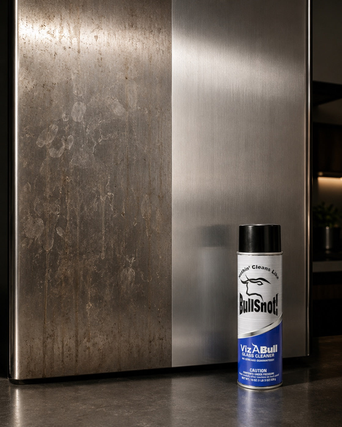 Before and after: a stainless panel smeared with water marks and grime on the left, wiped streak-free on the right, with the VizABull can beside it.