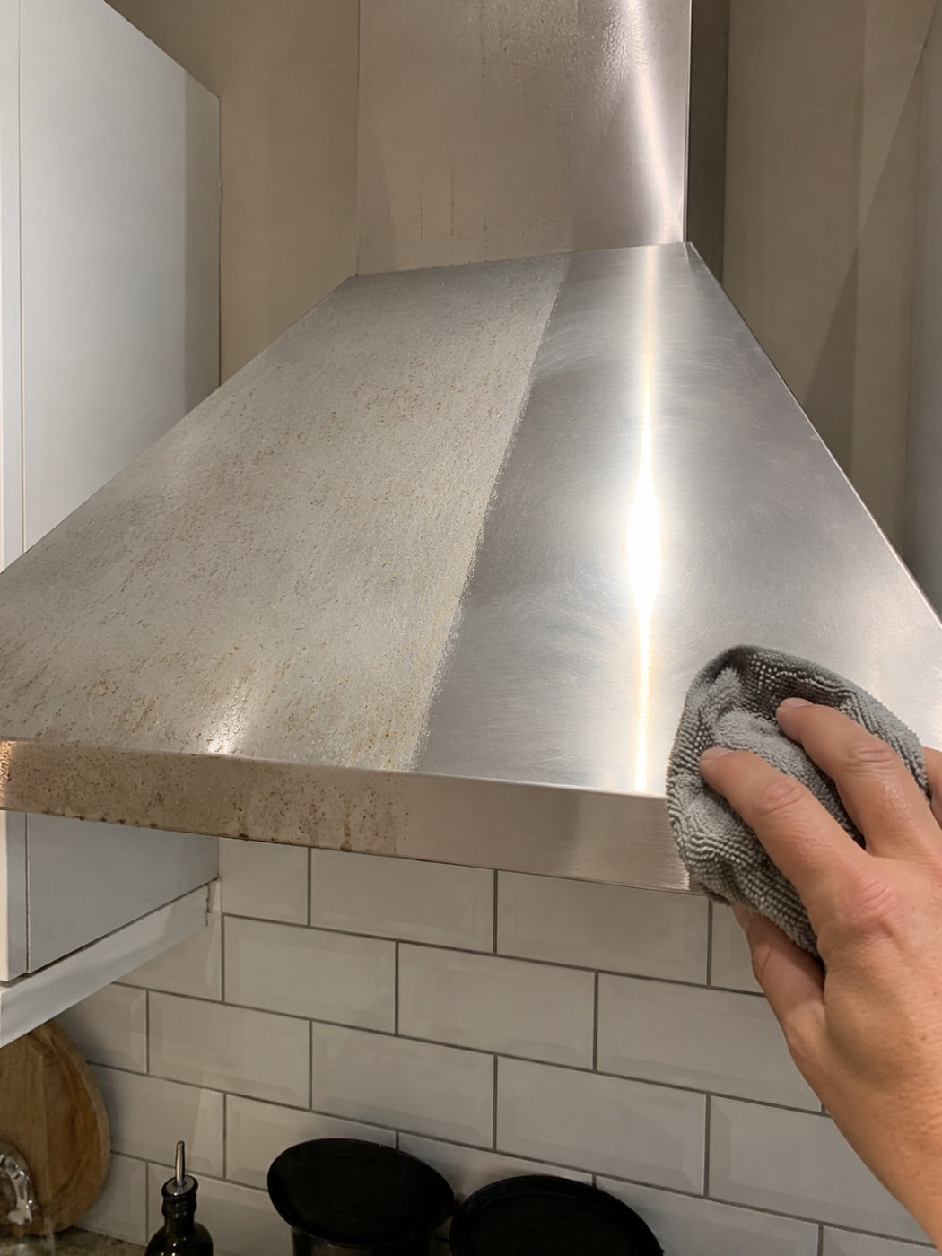 Stainless extractor hood wiped from dull to bright.