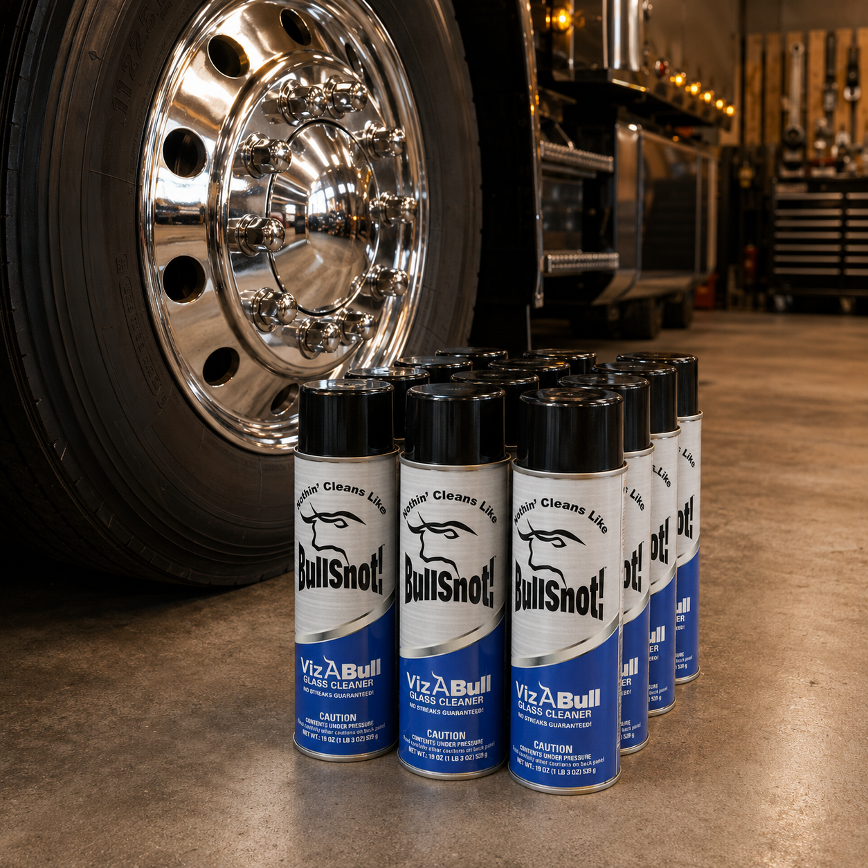 A twelve-pack of VizABull glass cleaner cans by a polished truck wheel